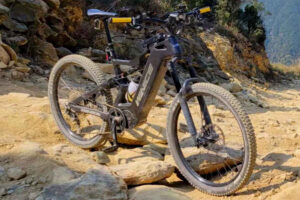 DengFu E55 riding on a winding bumpy gravel mountain road